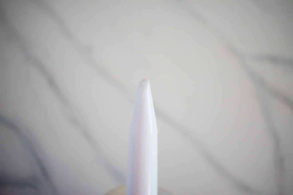 Close up image of an open tube of silicone caulk.