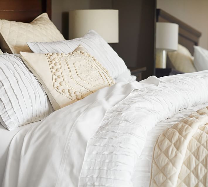 Mix of white and ivory bedding from Pottery Barn for the One Room Challenge